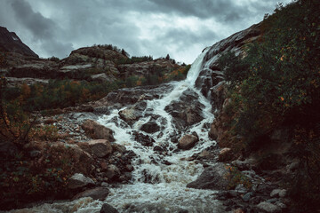 Caucasus, Dombay, Alibek waterfall in cloudy weather, dramatic landscape