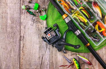 accessories for fishing on a wooden background. selective focus.
