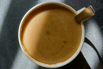 The light falls beautifully on a mug of freshly brewed coffee.