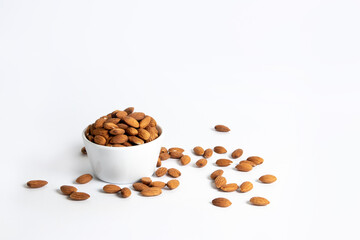 Almond in a white ceramic bowl on white background
