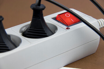 Connected electrical devices in an extension cord on a brown background