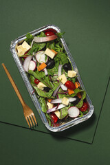 Healthy vegan take away salad in aluminum container