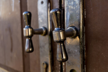 metal rustic door handles at wooden brown doors