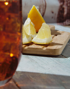 very cold cola on a white background with ice and lemon