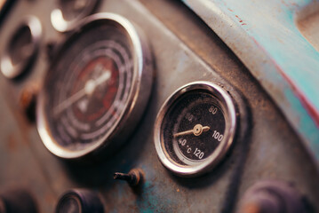 Old tractor dashboard. Temperature scale closeup.