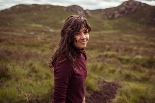 young woman hiking in the Scottish countryside
