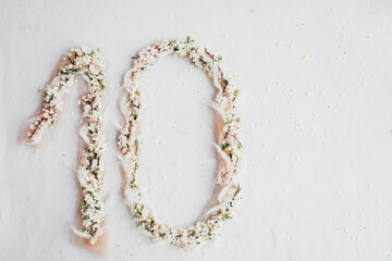 The number ten from flowers. The figure is made of flowers.
