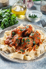 Meatballs with tomato sauce served with pappardelle pasta