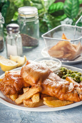 Fish in beer batter and chips with green pea and tartar sauce