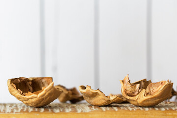 Walnut shells on cutting board against wall