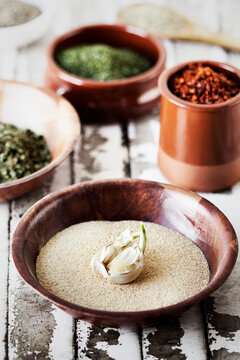 High angle view of garlic in semolina with herbs and ingredients on table