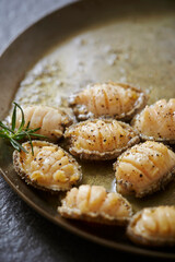 Grilled fresh abalone on a cast iron pan