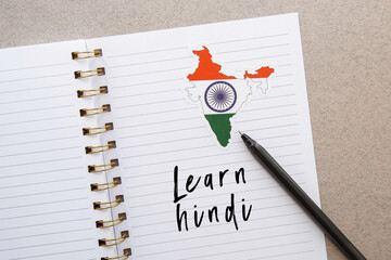 notepad with the inscription learn hindi, india flag and country map, pen, foreign language...