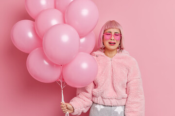 Unhappy desperate woman cries as none come on her party feels lonely and upset holds bunch of...