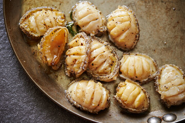 Grilled fresh abalone on a cast iron pan