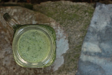 special concept selective focus matcha tea healthy diet juice and stone, leaf natural green background. Top view. Copy space for your text 