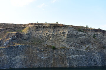 Fototapeta na wymiar Sheer cliff with lake at the bottom