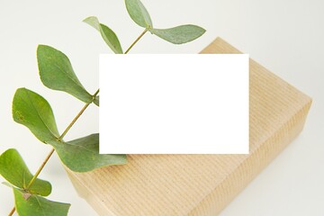 Blank card, gift box and eucalyptus branch, gift, shop, business or Thank you card mockup for design presentation.