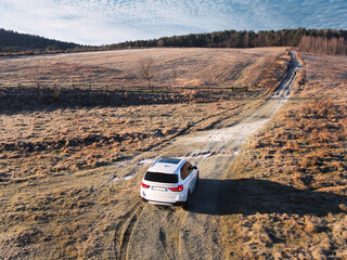 overhead top view of the suv car going by trail road