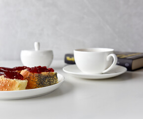 cup of tea (coffee) with bun and jam