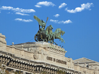 Zoom photo of horse sculptures on top of Supreme Court of Cassation in Rome, Italy