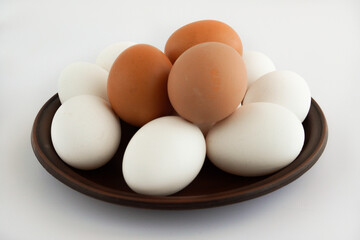 Chicken eggs on ceramic plate, isolated white background