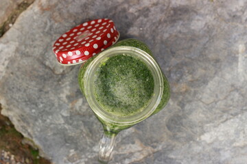 special concept selective focus antioxidants drinking healthy diet juice and stone, leaf natural green background. Top view. Copy space for your text 