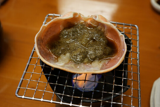 Crab miso paste with crab shell plate on Japanese bbq grill called Shichirin. Echizen Crab, in Fukui, Japan - 越前 ガニ 七厘 福井 日本