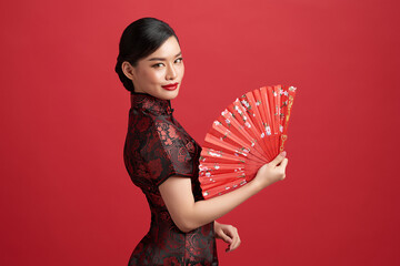 Asian chinese woman in traditional dress on red background. Chinese new year festival.