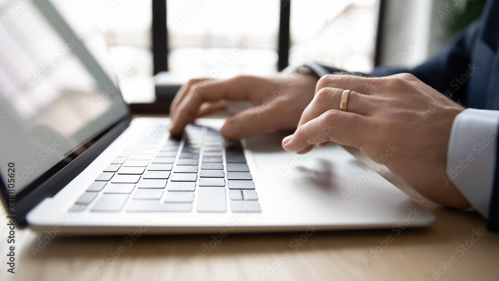 Poster crop close up of male ceo or employee work distant on laptop write email letter to business partner 