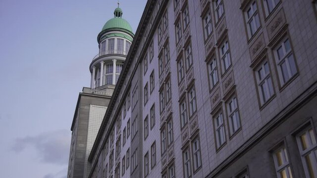 Dolly slide of Frankfurter Gate vintage building in Berlin during dusk.
