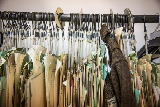 Cardboard patterns and jacket hanging on clothes rack at Design Studio