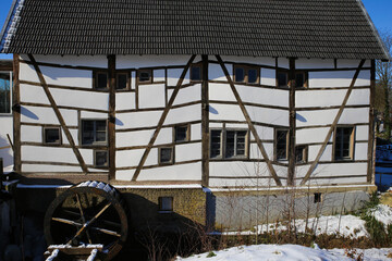 View on isolated half timbered facade with paddle wheel of old water mill - Wegberg, tuschenbroich, Germany