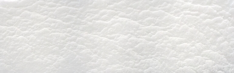 Snow texture background..A snowdrift of many snow layers. .A deposit of snow sculpted by the wind..Еmbossed snow surface..Winter concept..White background. Close up..Panoramic image. Hi-res banner. - 413807880