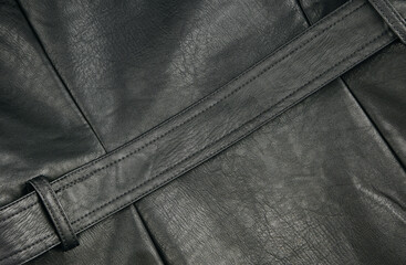 Black leather fabric textile material texture pattern macro blur background.