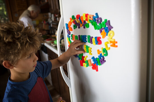 Boy playing with magnet letters