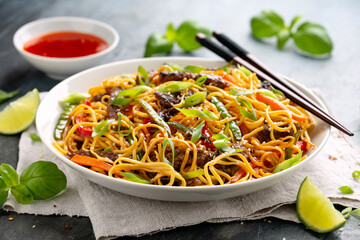 Stir fry noodles with beef and vegetable in white bowl. asian style food