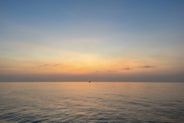 Fototapeta premium Beautiful evening seascape with offshore platform in the middle sea horizon and clear sky, natural photo.