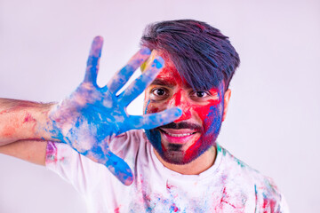 Portrait of happy indian person on holi color on white cotton t-shirt