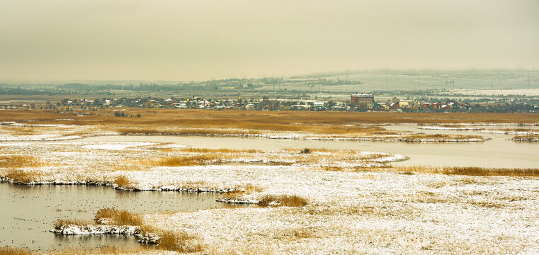 winter steppen landscape with the urban horizon