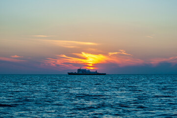 Fototapeta na wymiar A Ferry and a Sunset