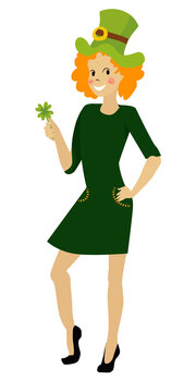 Red-haired girl joyous in a green dress celebrates St. Patrick's Day. the girl holds a clover in her hand