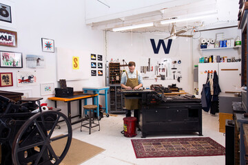 Serious man working in printing press