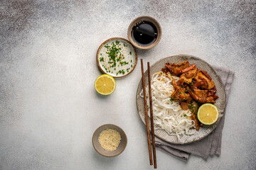 Asian food rice noodle served with chicken in Teriyaki sauce and sesame seeds, top view