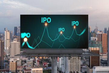 IPO icon hologram on road billboard over sunset panorama city view of Kuala Lumpur. KL is the hub...