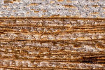 Stack of matzot sheets close-up. Symbol of Jewish Passover.
