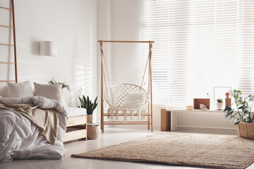 Comfortable hammock chair in stylish room. Home interior