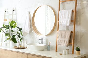Decorative ladder near vessel sink in stylish bathroom. Idea for interior design