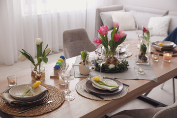 Beautiful Easter table setting with beautiful flowers in living room