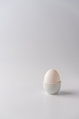 White egg on a white background with bright shadows